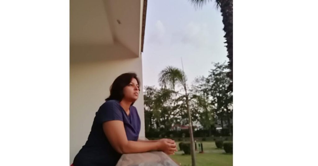 Suman standing in a balcony 